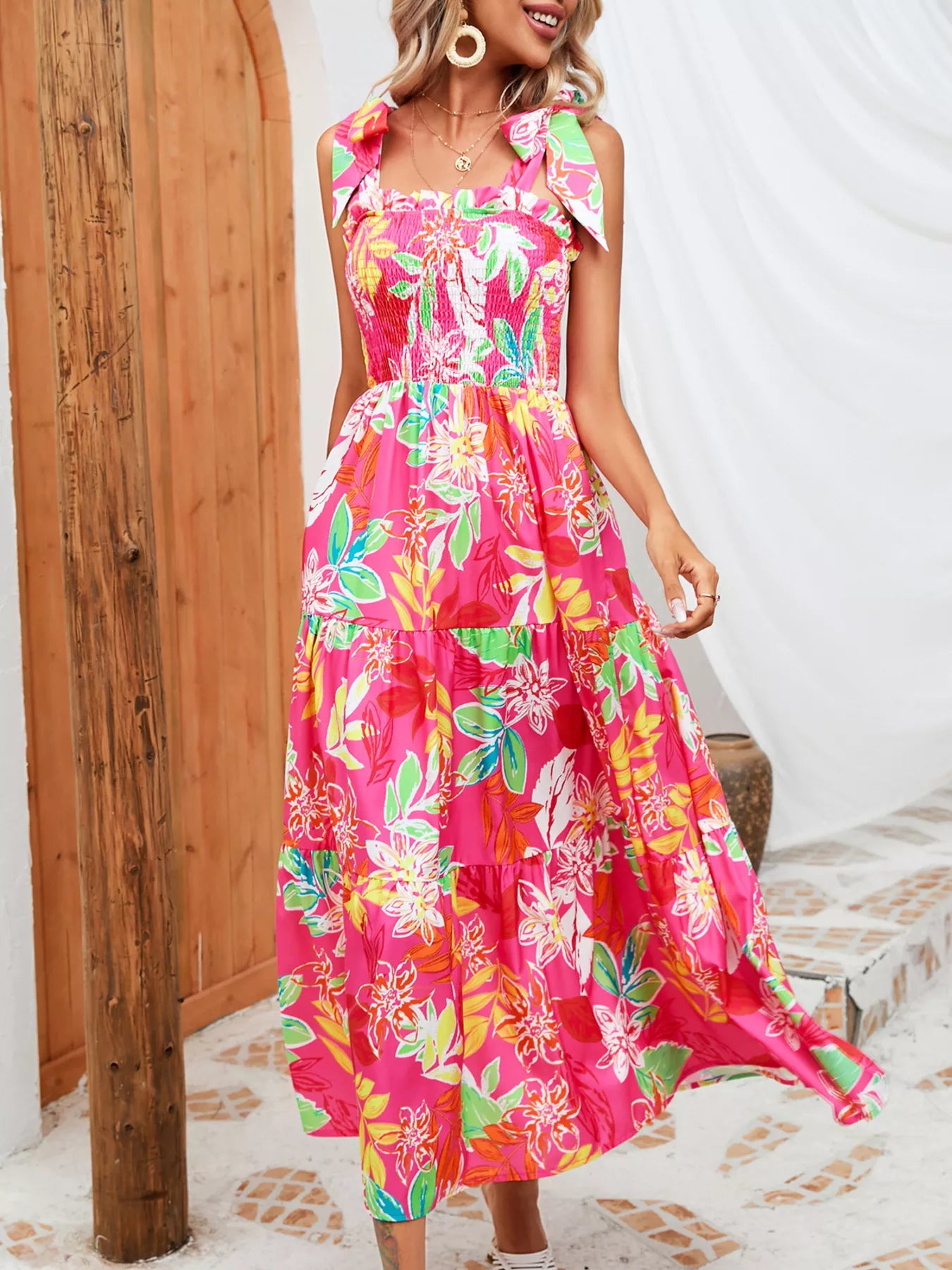 Pink tropical print smocked tie-strap midi dress with tiered skirt and ruffled straps