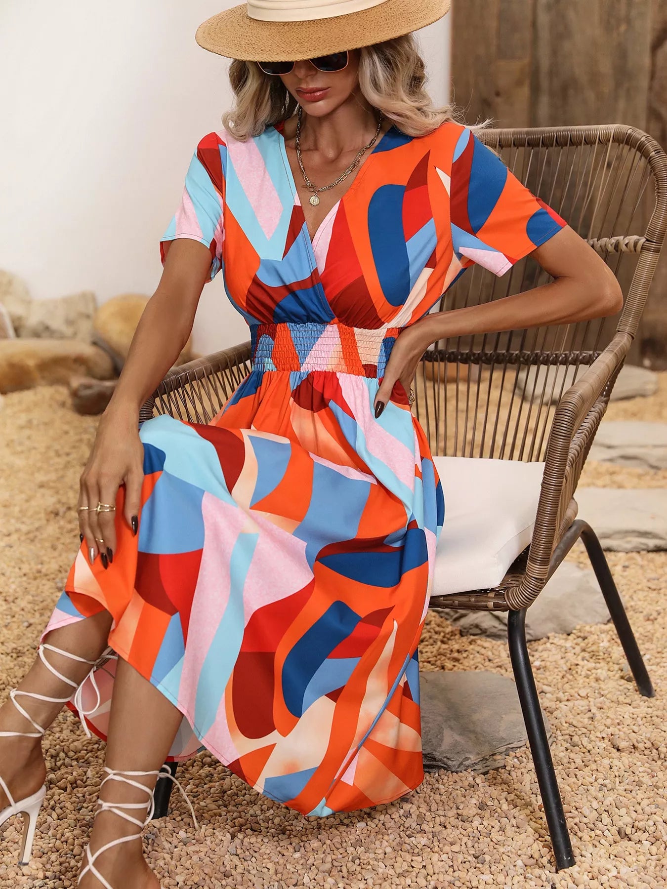 Printed short sleeve midi dress with orange, red, and blue abstract geometric pattern