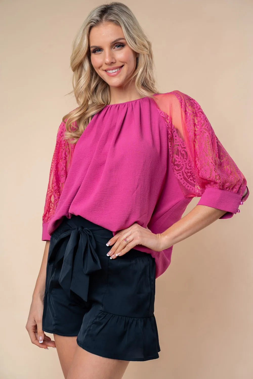 Smocked high-waisted dark navy shorts with bow tie and tiered ruffles