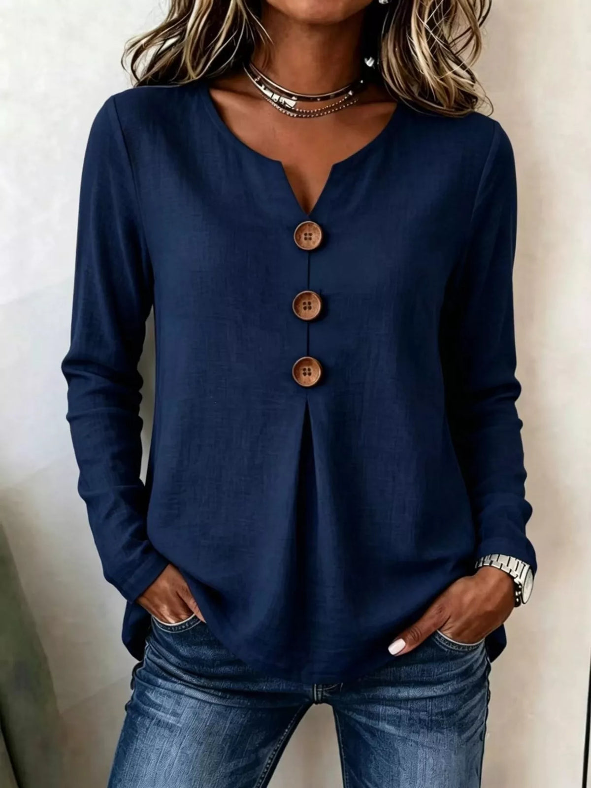 Navy blue long sleeve blouse with V-neck and decorative button placket