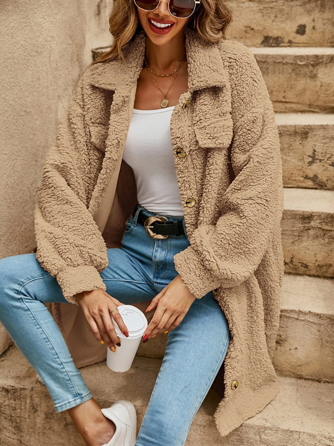 Tan collared button-down sherpa coat with button front and two flap chest pockets