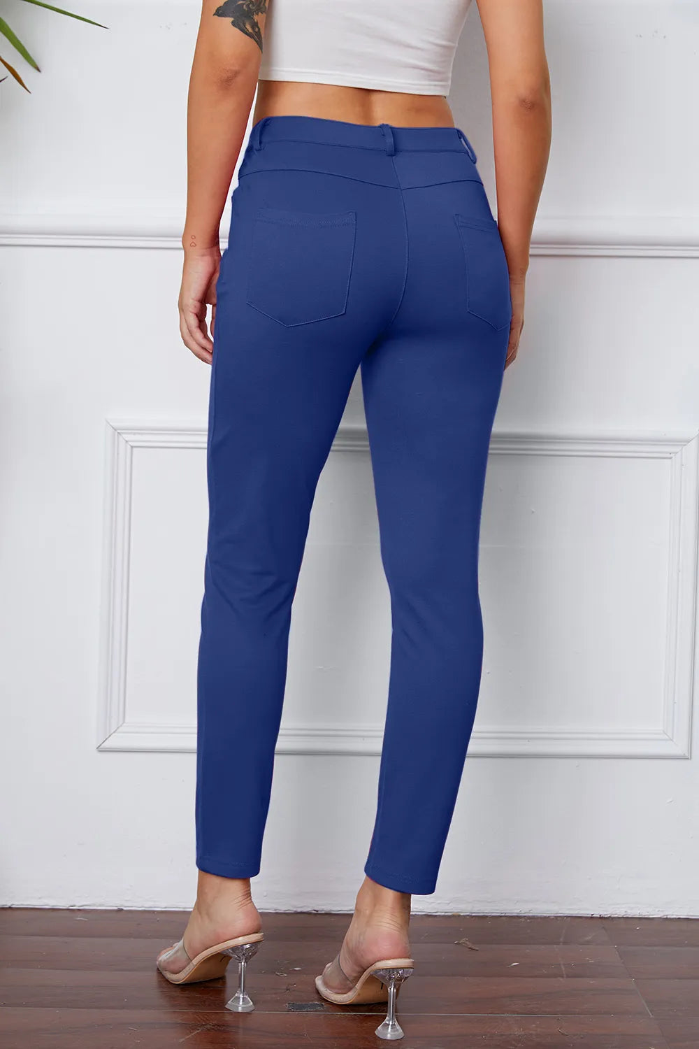 Women's royal blue stretch pants with belt loops, front pockets, and ankle length