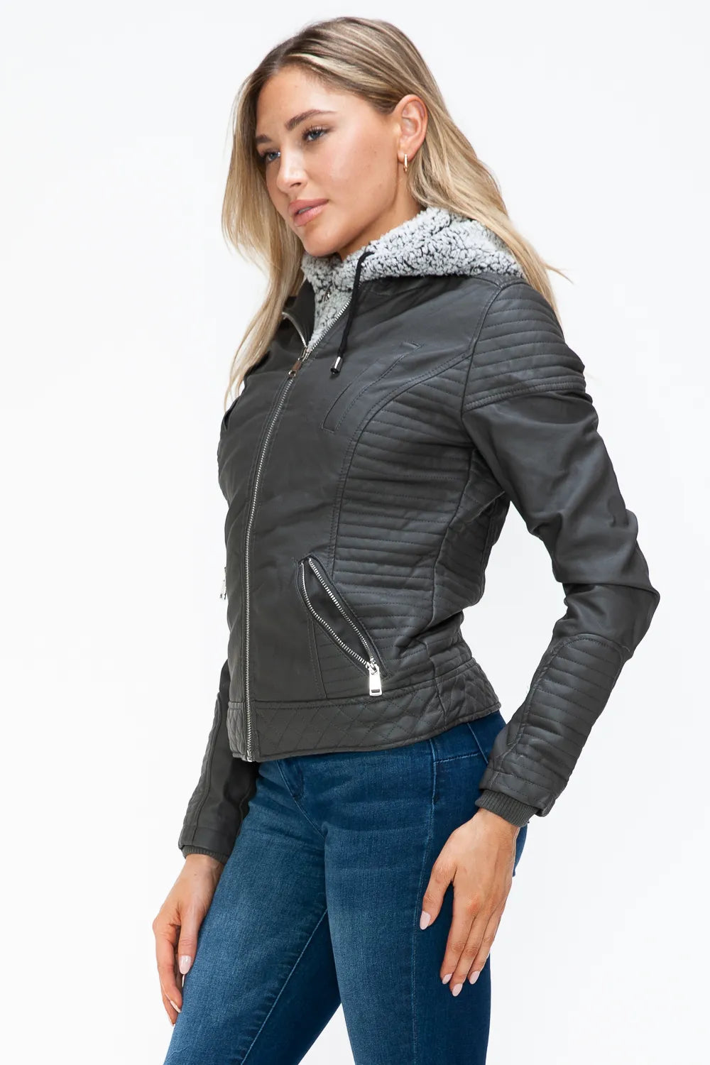 Charcoal zip jacket with fuzzy hood lining and angled front pockets, side view.
