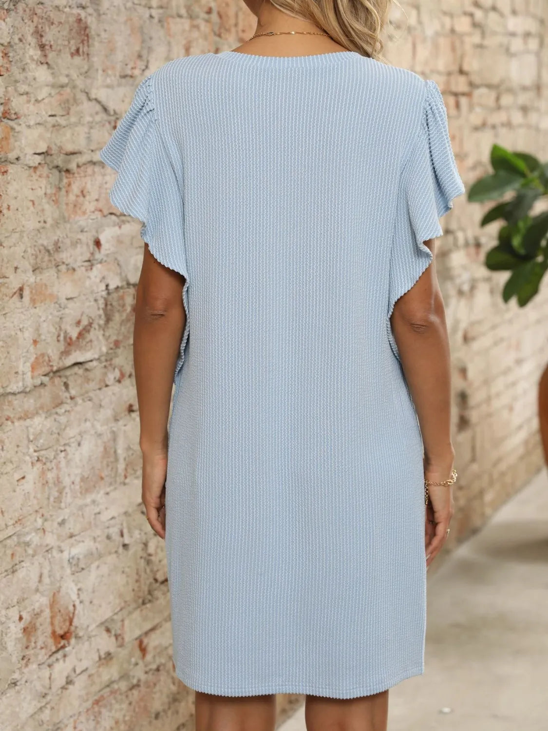 Ruffled V-Neck Cap Sleeve Mini Dress in light blue ribbed fabric, back view