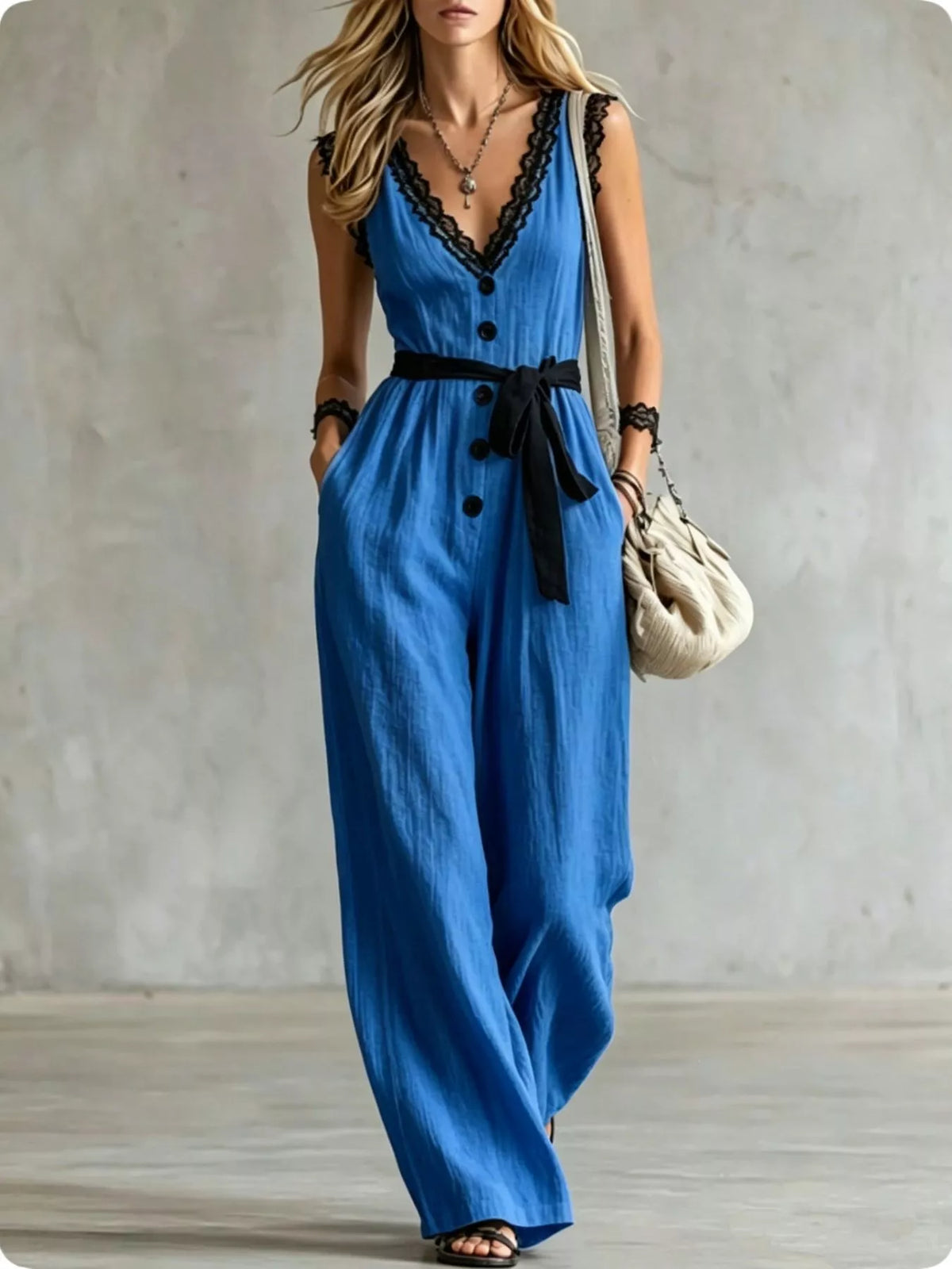Blue lace-trim V-neck sleeveless jumpsuit with black ribbon waist tie and button detail