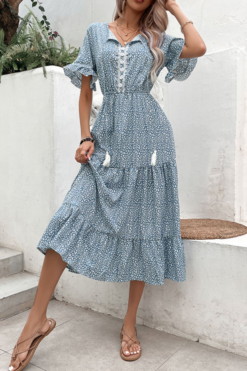 Light blue printed tiered midi dress with tassel-tie buttons and short ruffle sleeves