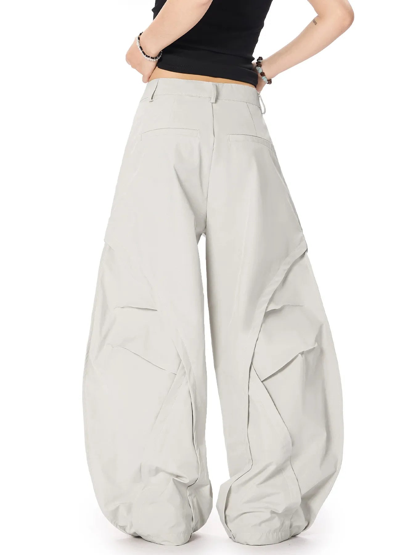 Light gray oversized wide-leg cargo pants with side flap pockets and roomy fit