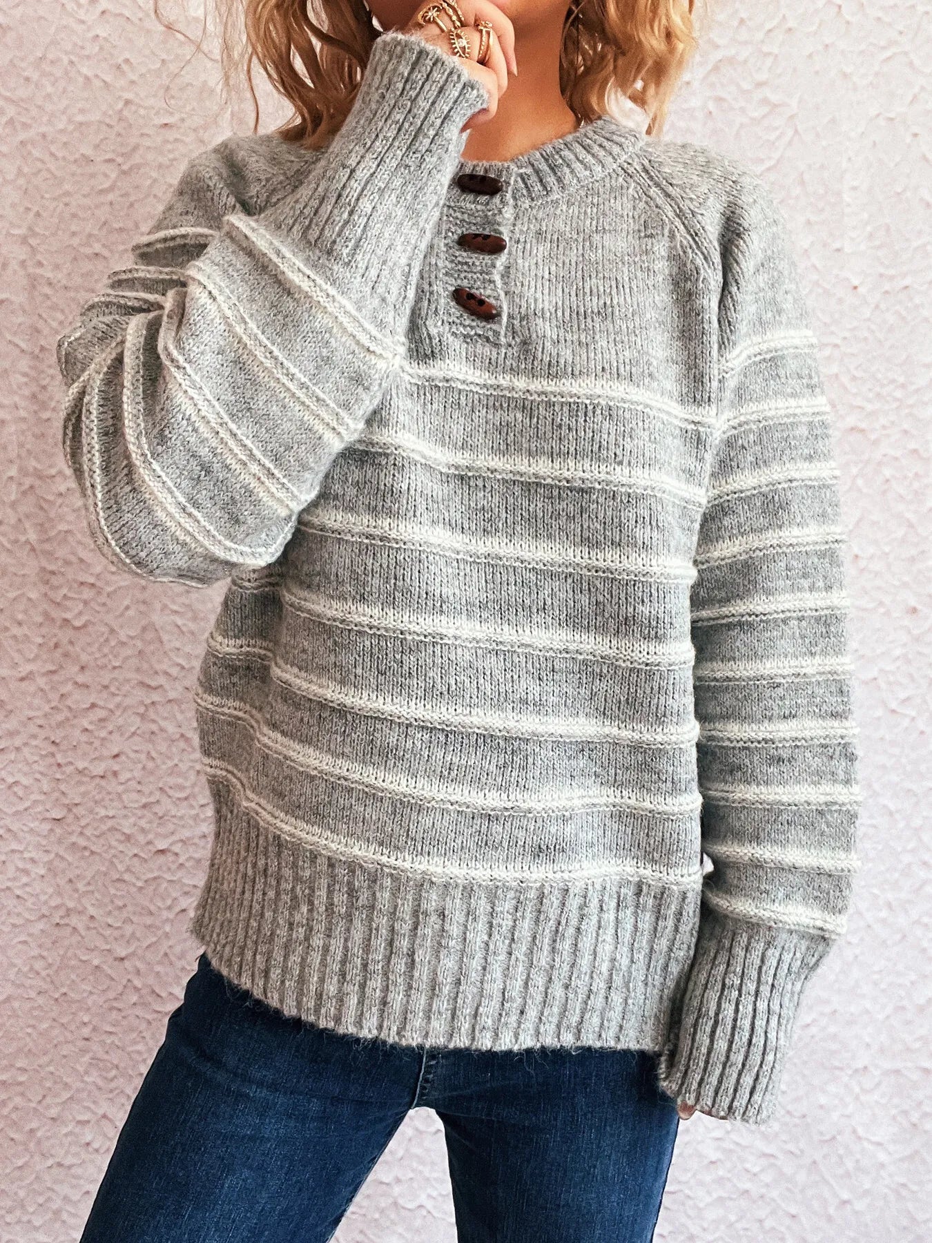 Gray striped knit long-sleeve sweater with three-button placket and ribbed cuffs