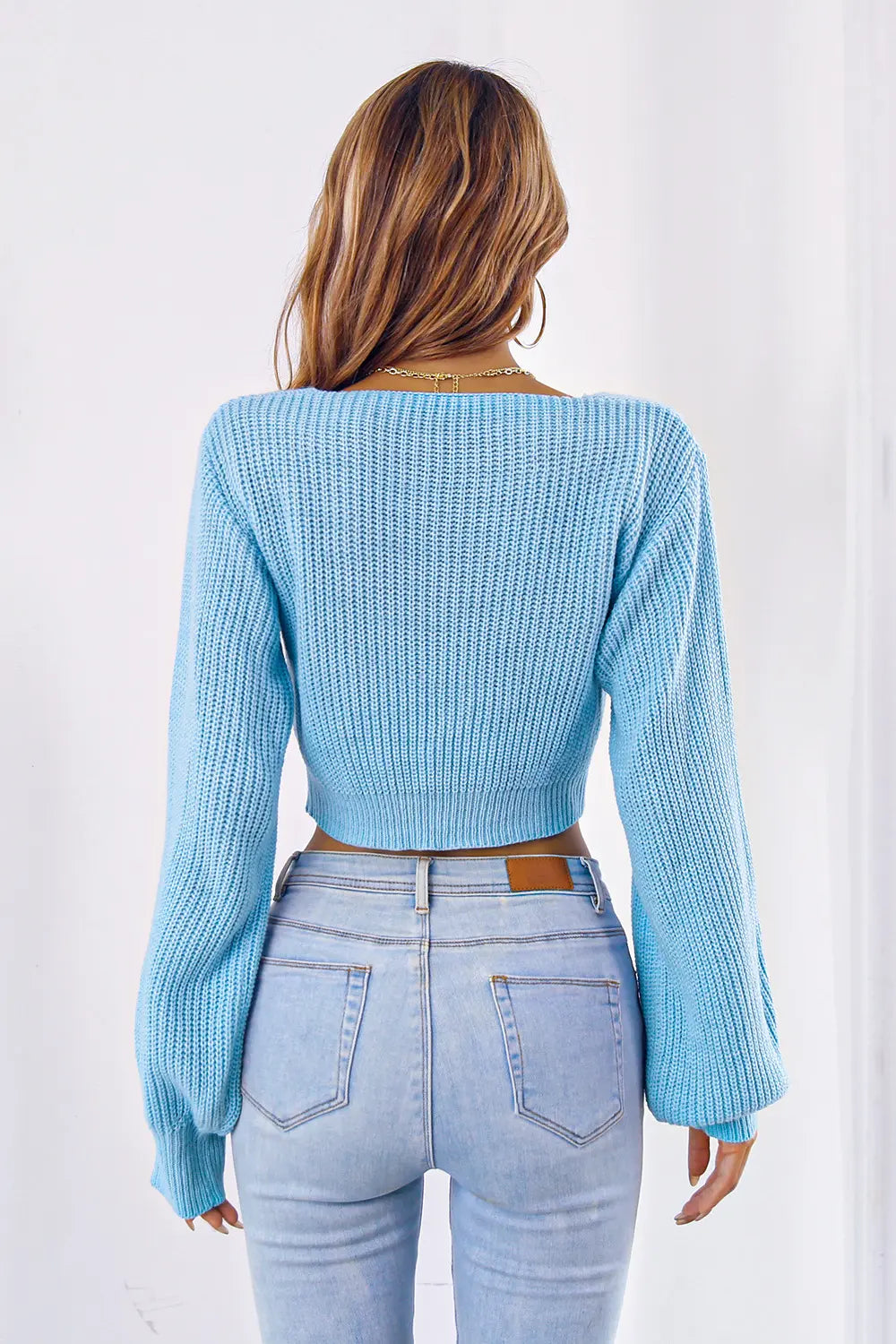 Pastel blue knit bow V-neck cropped sweater, back view with long sleeves