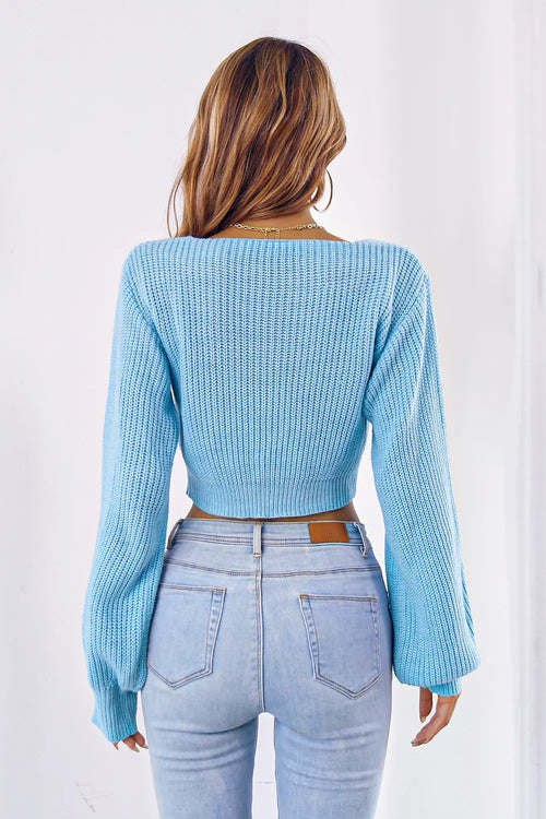 Pastel blue knit bow V-neck cropped sweater, back view with long sleeves