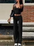 Black halter neck crop top and wide-leg pants set with matching bottoms