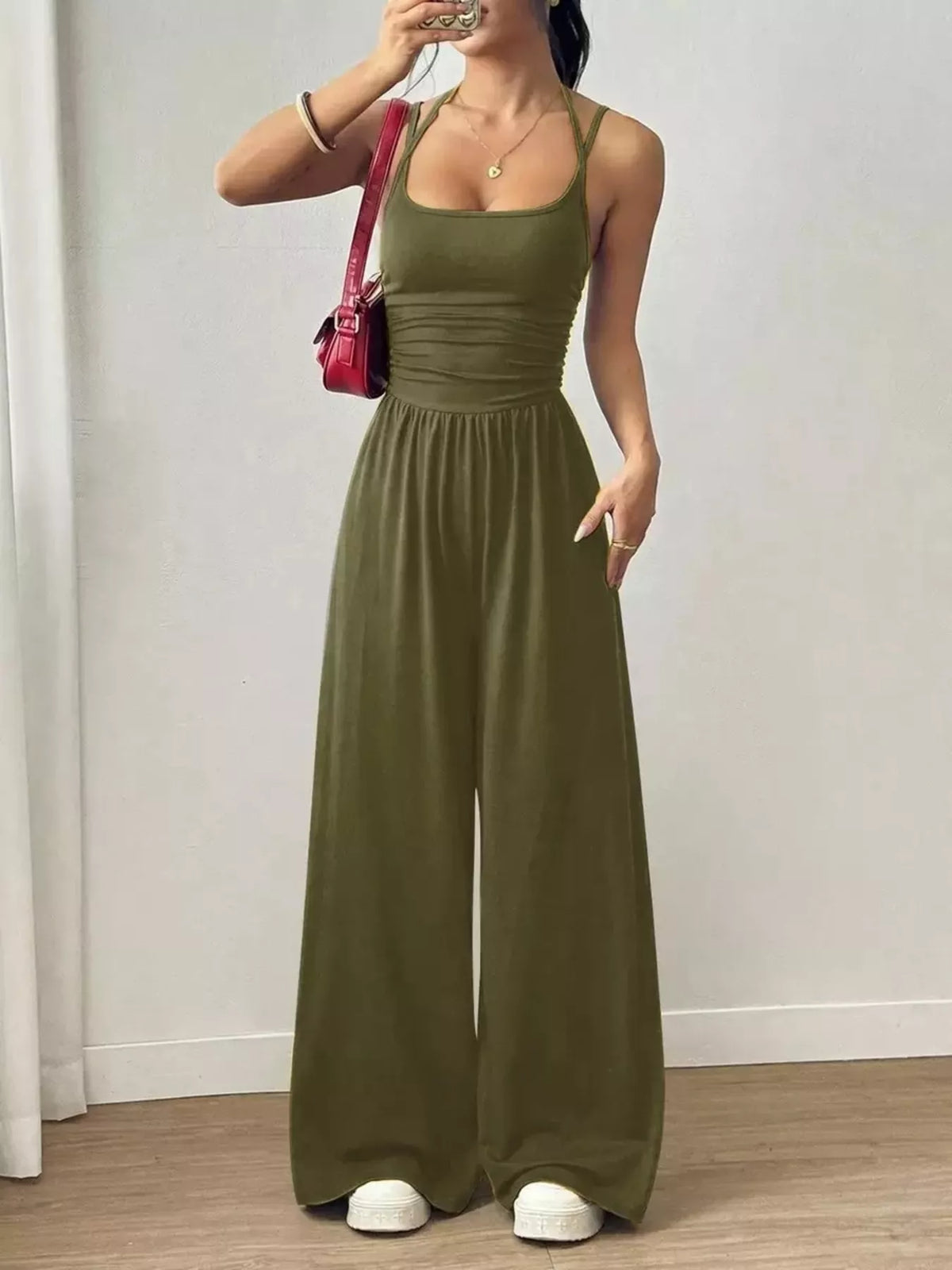 Olive green spaghetti strap wide-leg jumpsuit with smocked waist and wide pant legs