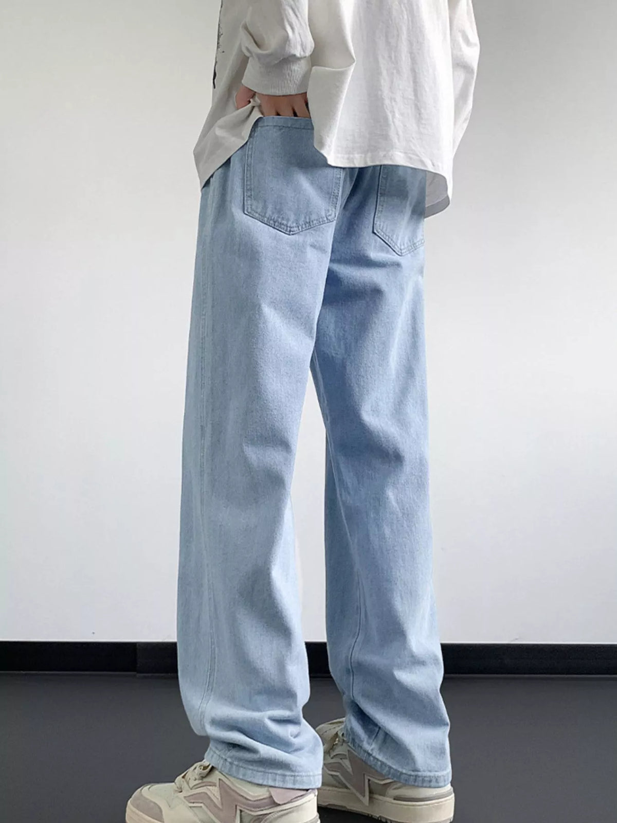 Men's loose-fit washed denim jeans with drawstring waist, light blue