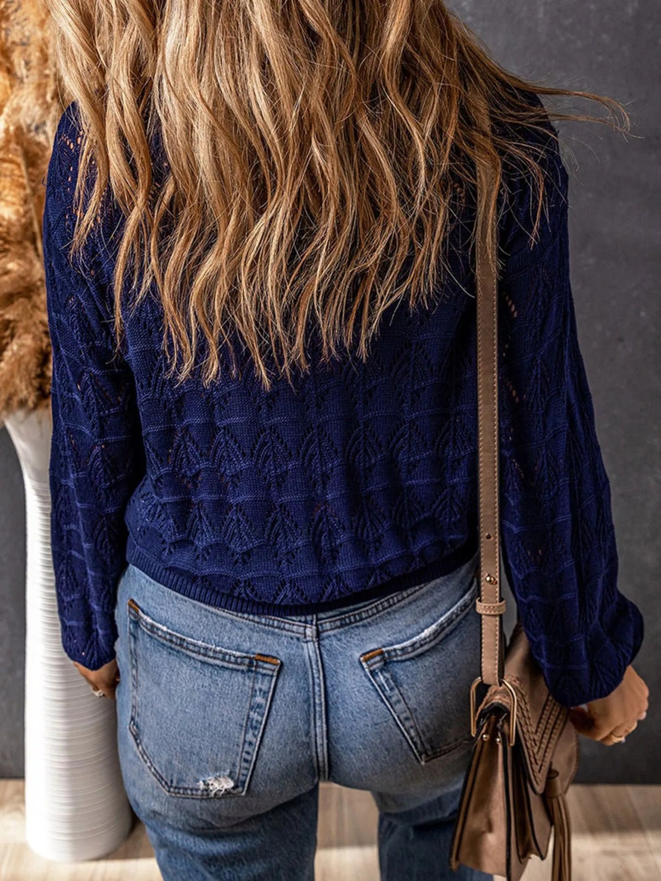 Blue openwork cardigan back view with long sleeves and textured diamond knit pattern