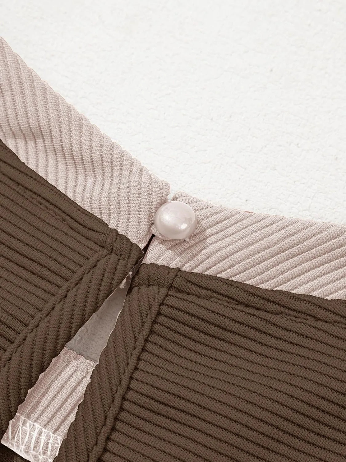 Round Neck Cap Sleeve Mini Dress in beige and brown ribbed fabric with pearl button detail.