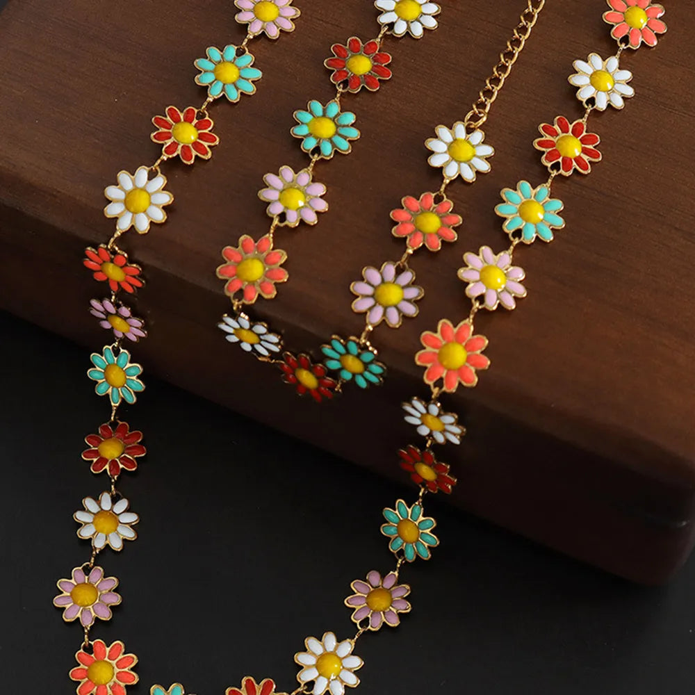 Gold-tone chain necklace with multicolor daisy charms