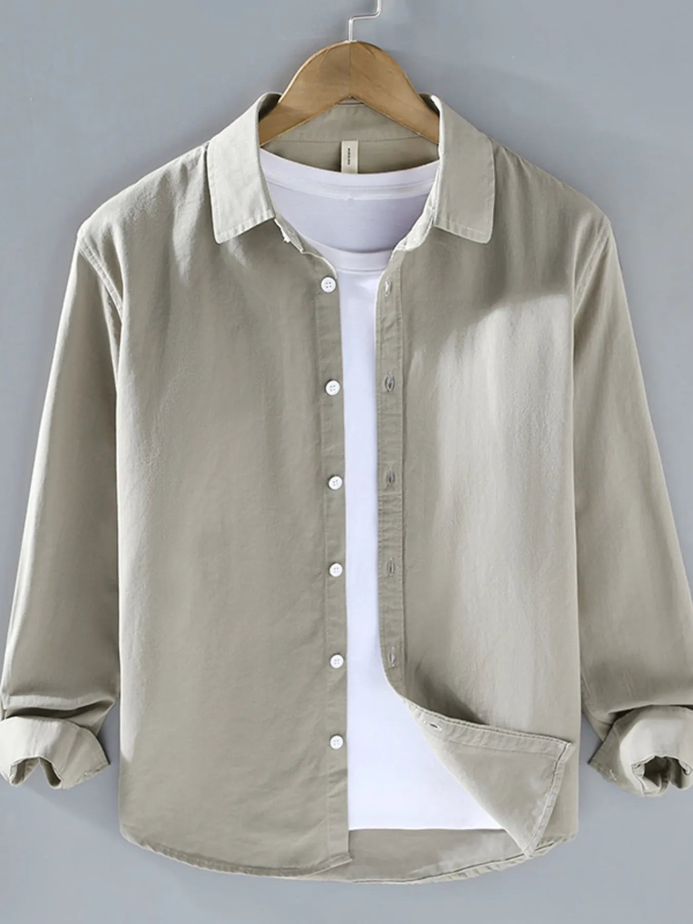 Light gray button-up long sleeve shirt with pointed collar and front button placket.