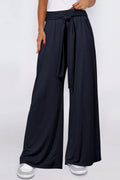 Dark navy wide-leg pants with tied waist and side pockets, flowy full-length legs.