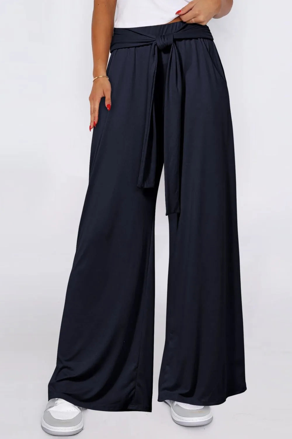 Dark navy wide-leg pants with tied waist and side pockets, flowy full-length legs.