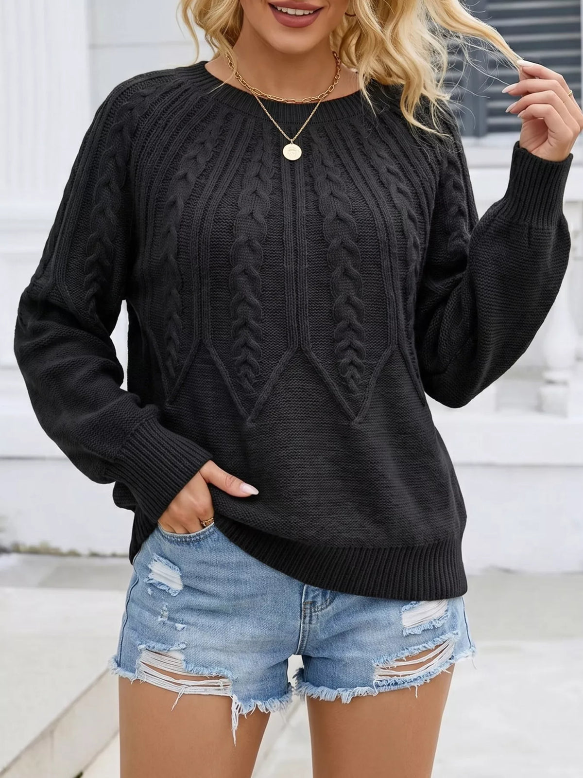 Black cable-knit round neck pullover sweater with long sleeves