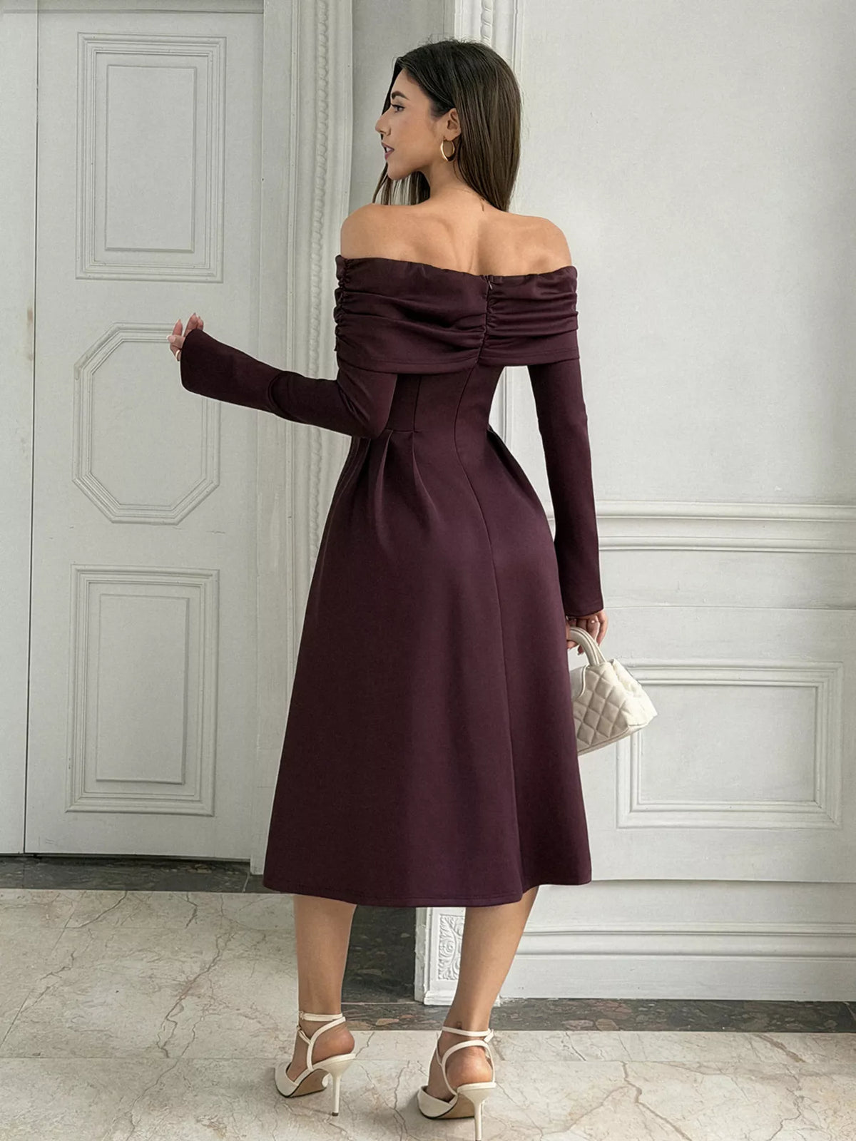 Burgundy off-shoulder midi dress with long sleeves and ruched neckline, pleated skirt
