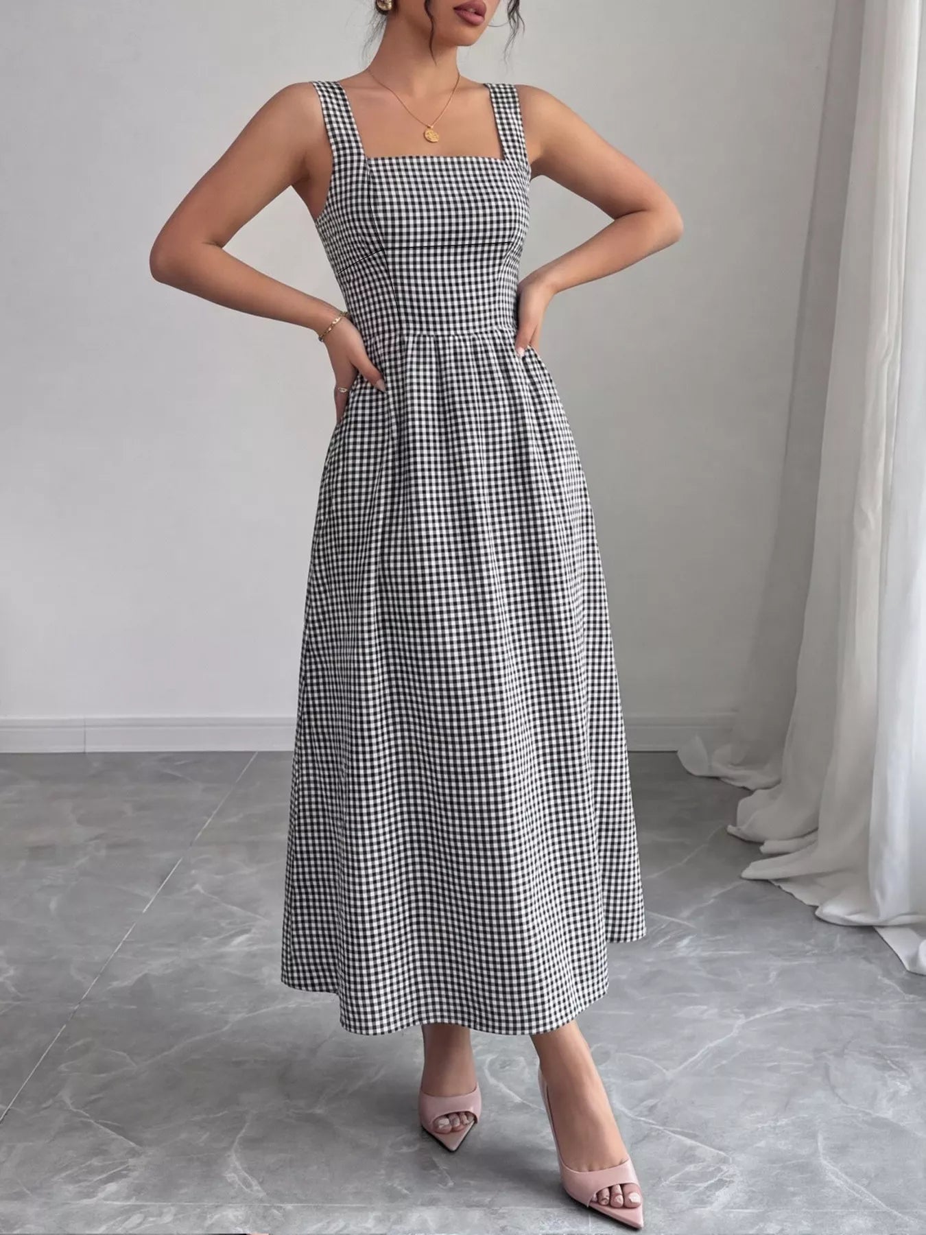 Black-and-white gingham square-neck sleeveless midi dress, cinched waist and long skirt