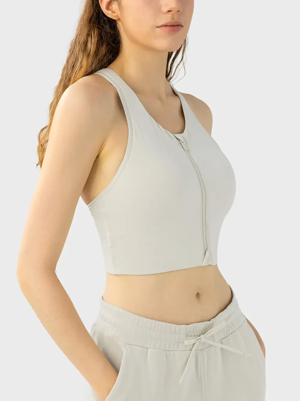 Ivory wide-strap sport bra with front zipper and racerback