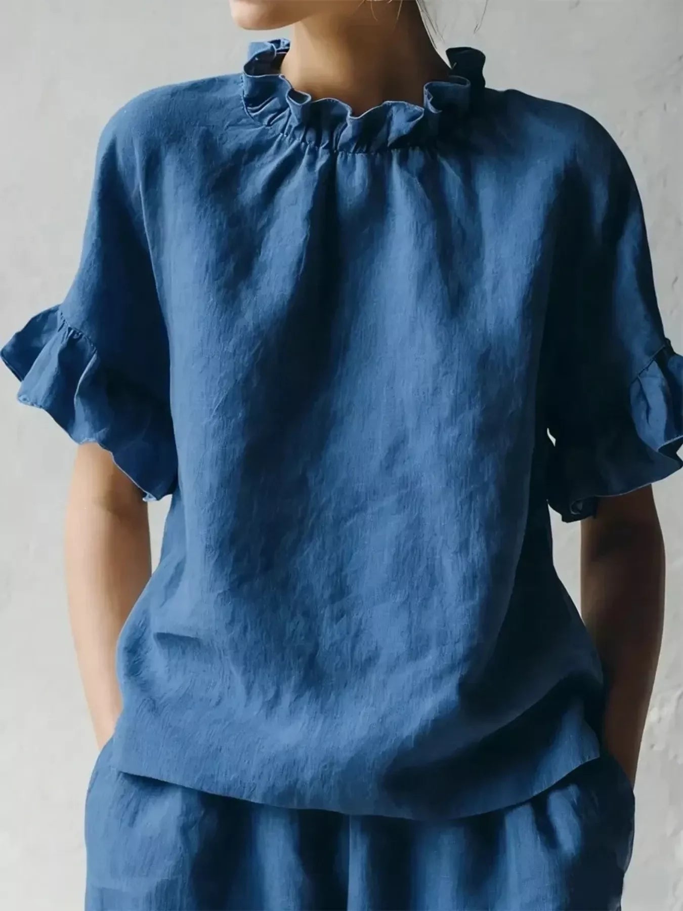 Blue ruffled neck half-sleeve blouse with gathered high neckline and flared sleeves