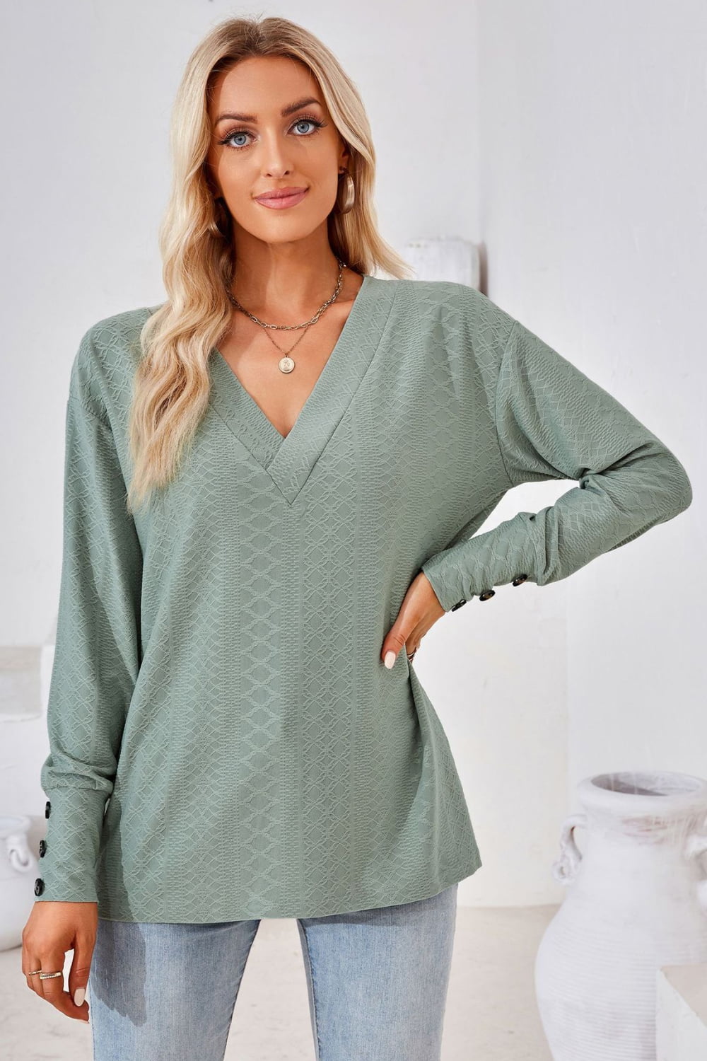 Sage green V-neck long-sleeve blouse with textured diamond pattern and long sleeves