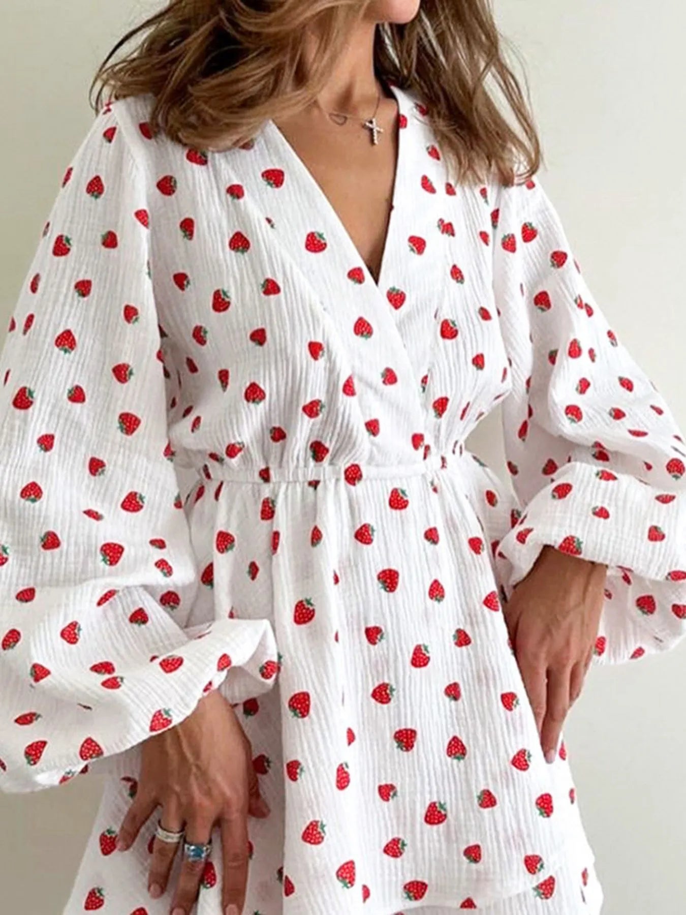 Strawberry-print long-sleeve mini dress, white textured fabric with a V-neck wrap