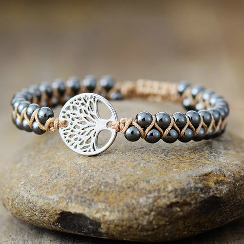 Silver braided bead bracelet with round tree-of-life charm and leather cord ties