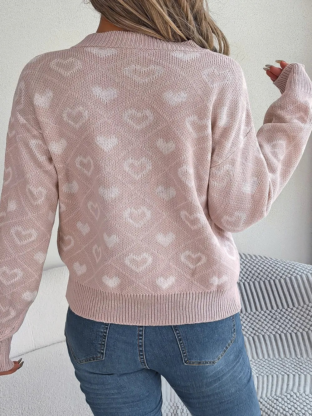 Blush pink heart-pattern knit sweater, V-neck, long sleeves in back view
