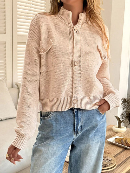 Apricot knit cardigan with button front and two flap pockets, ribbed collar and cuffs