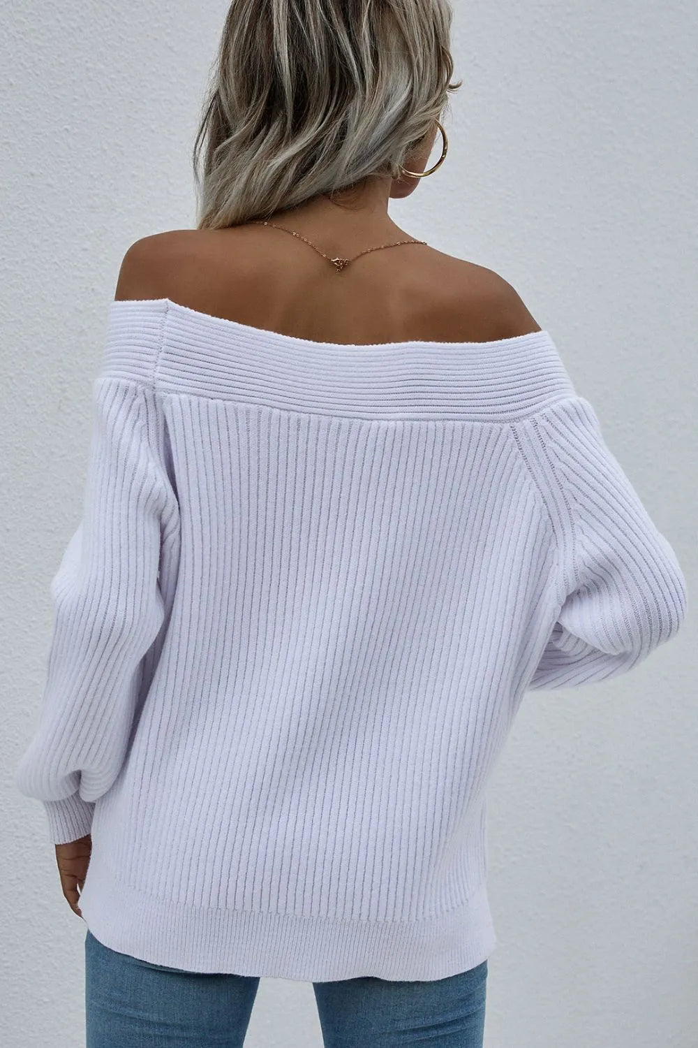 White off-shoulder rib-knit sweater, back view with ribbed knit and long sleeves.