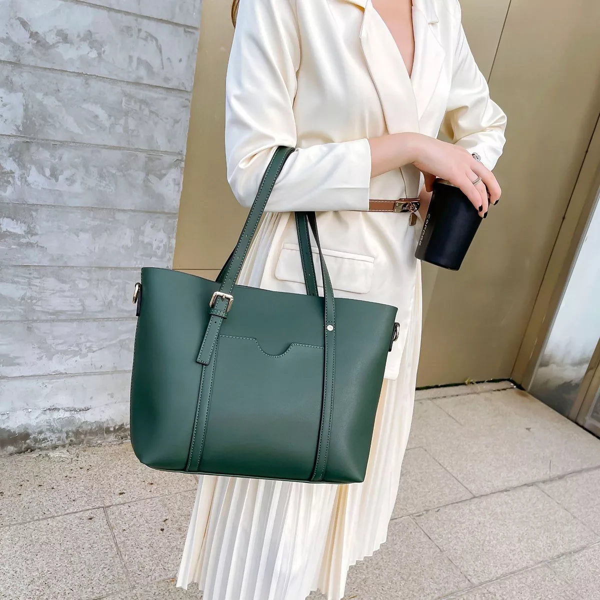 Green medium vegan leather tote bag with top handles, front clasp pocket, and side studs