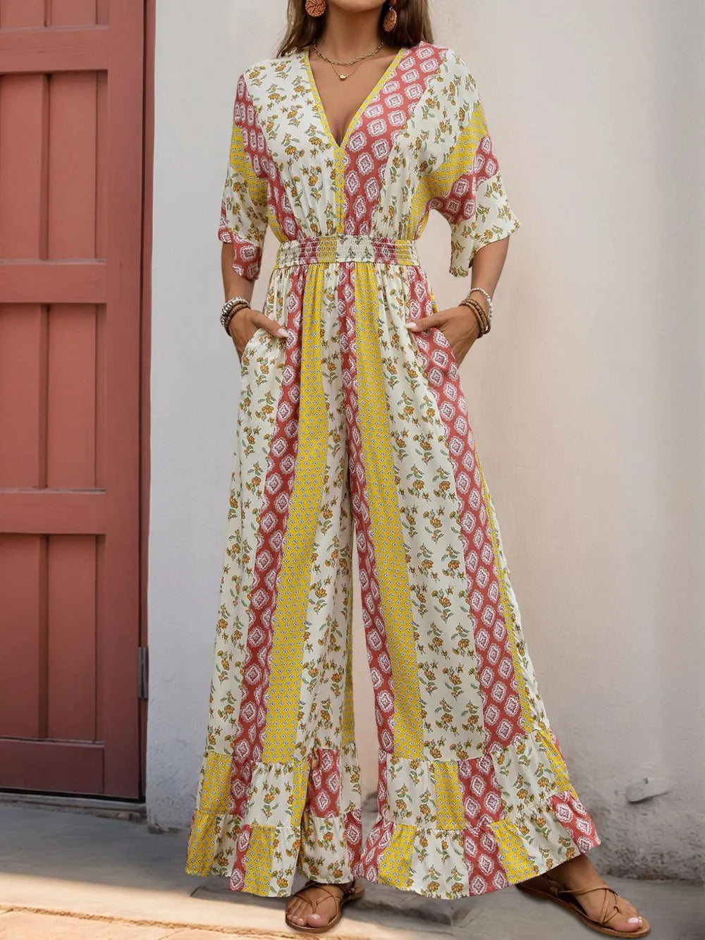 Multicolor printed V-neck jumpsuit with tie waist and ruffled maxi hem