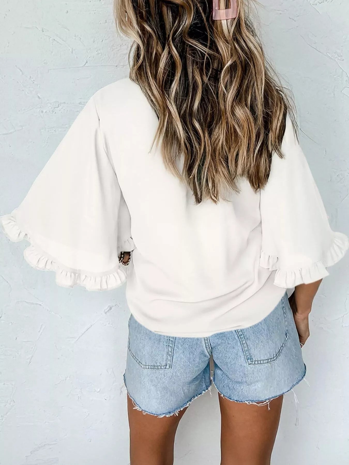 White ruffle-trim half-sleeve blouse, back view, voluminous puff sleeves.