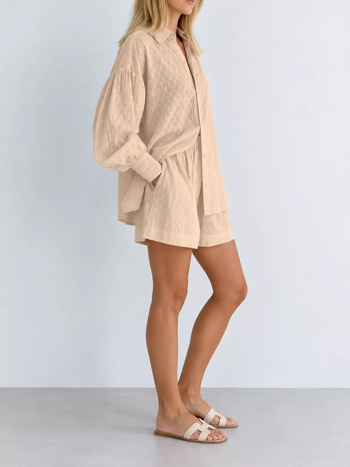 Blush pink textured button-down shirt and shorts set with long puff sleeves and tie waist
