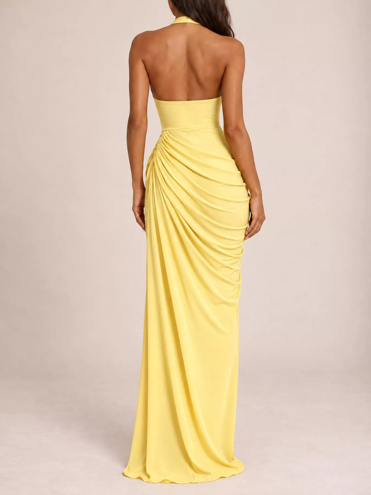 Back view of yellow halter neck maxi dress with ruched drape and high slit