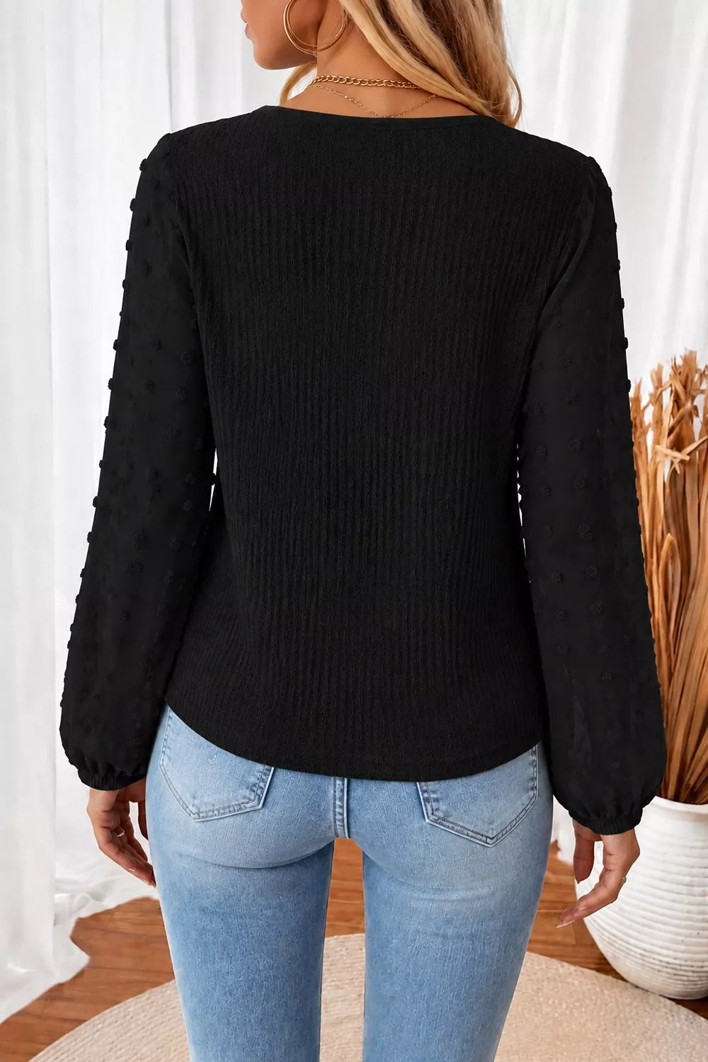 Black long-sleeve blouse with gathered swiss-dot sleeves and V-shaped back