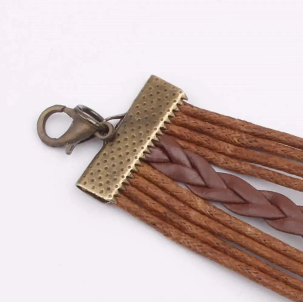 Brown vegan leather rope bracelet with hammered metal clasp and cutout tag