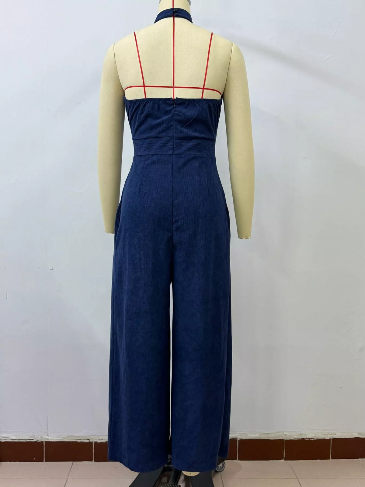 Blue halter linen jumpsuit back view with crisscross straps and wide legs