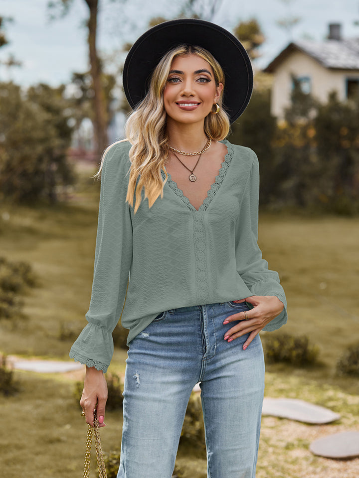 V-neck flounce-sleeve blouse in sage green, front view with ruffled V-neck trim