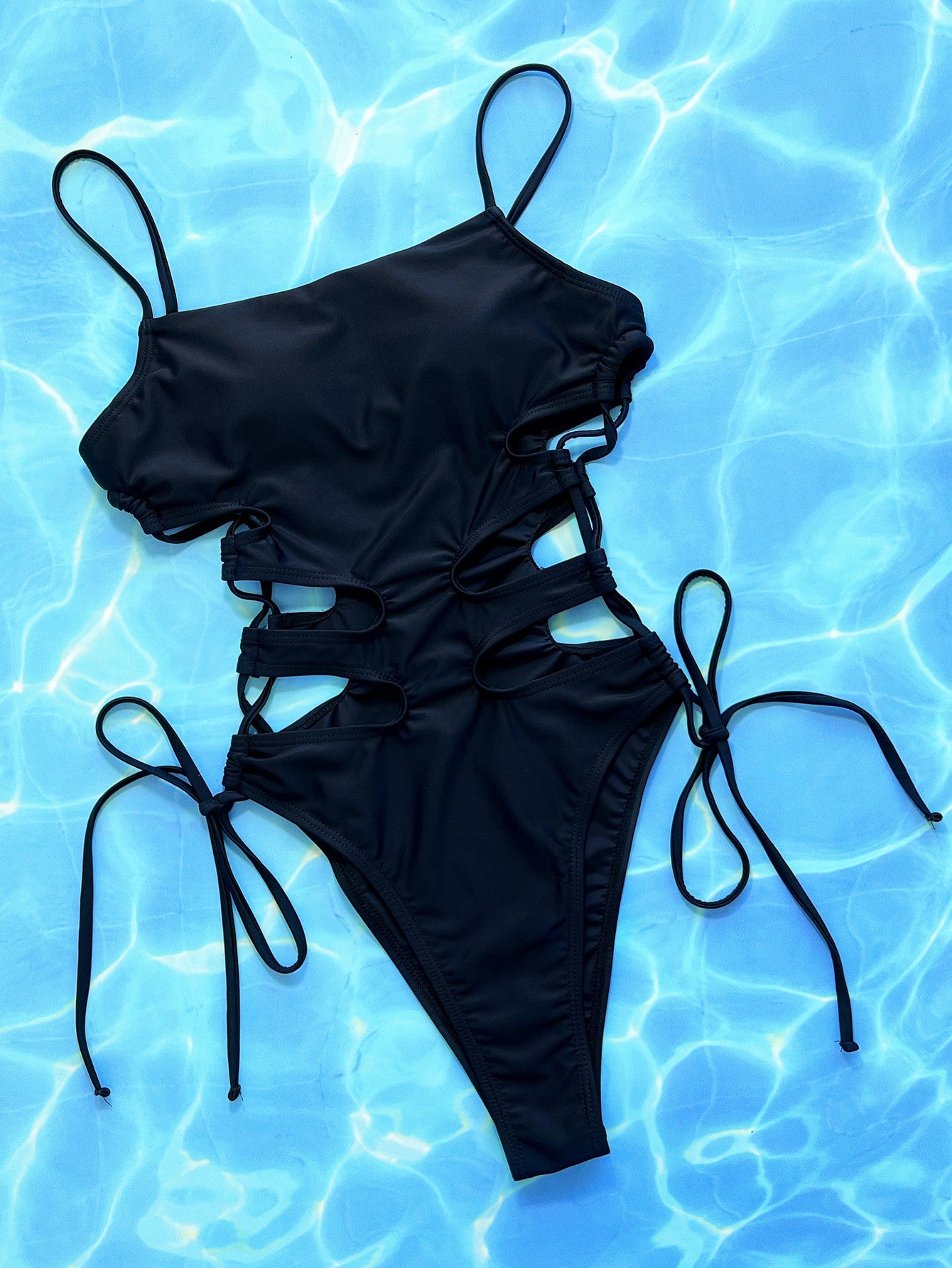 Black one-piece swimsuit with spaghetti straps and lace-up side cutouts