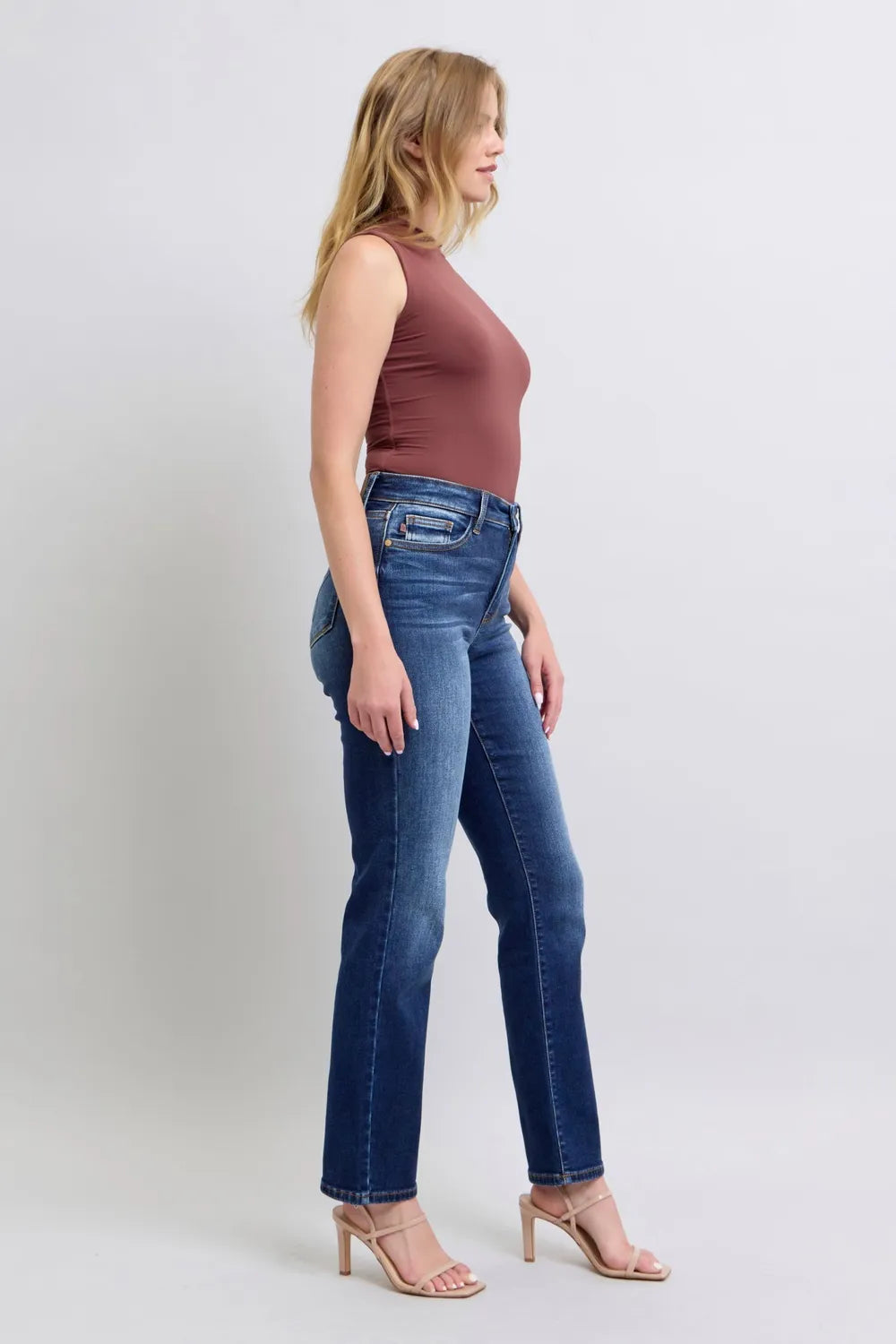 Washed dark blue straight-leg jeans, side view with front pockets and belt loops