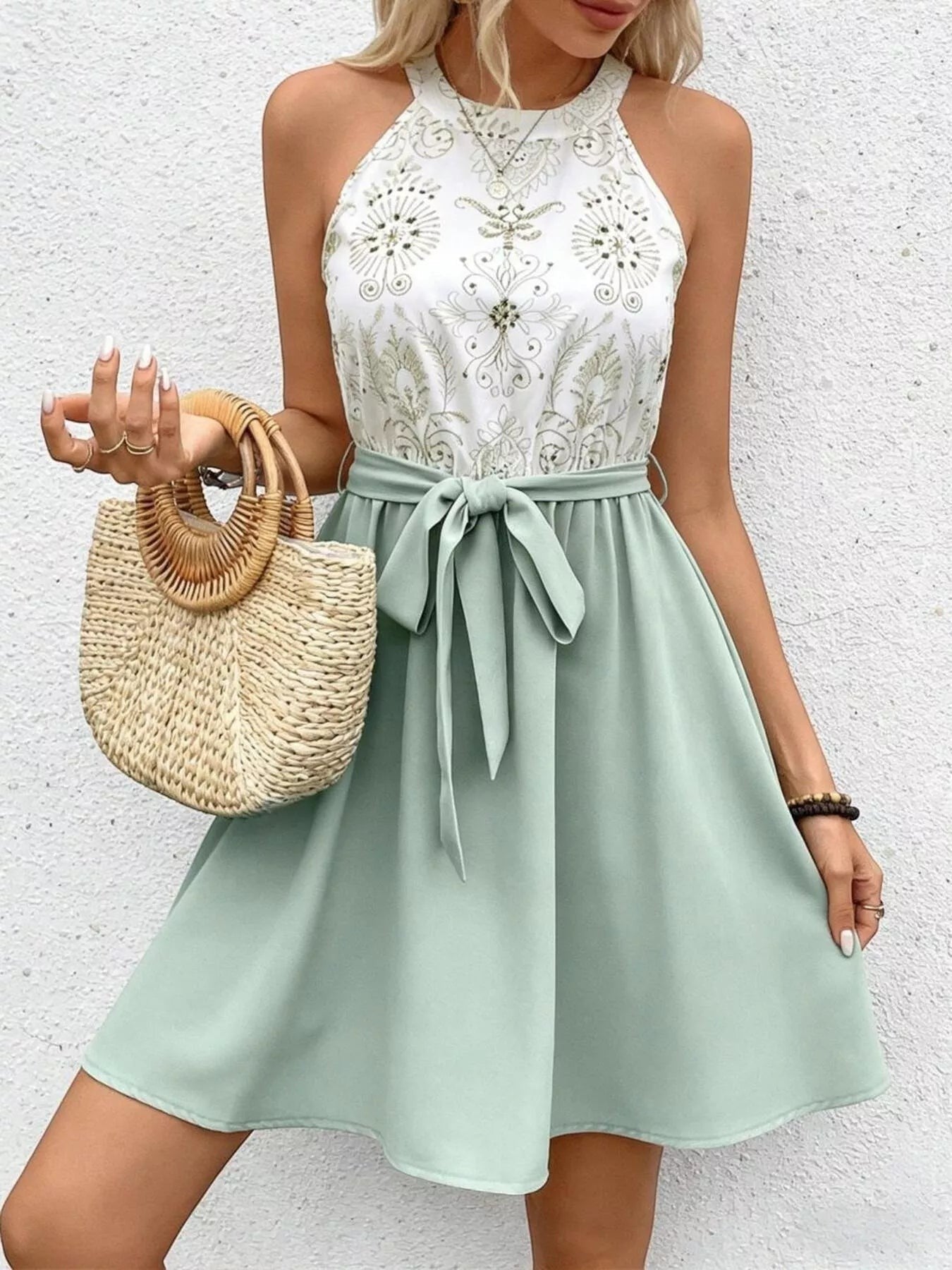 Cedar & Moore sleeveless A-line dress with white embroidered bodice and sage green skirt, featuring a tie waist.