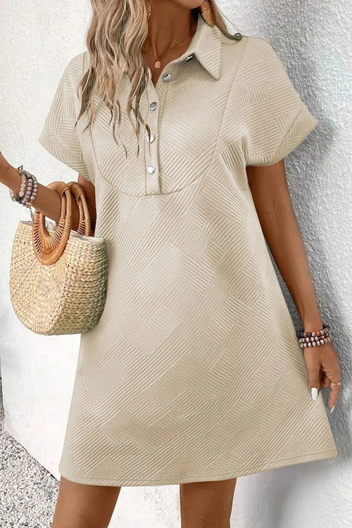 Beige button-front short-sleeve mini dress with pointed collar and chest buttons.
