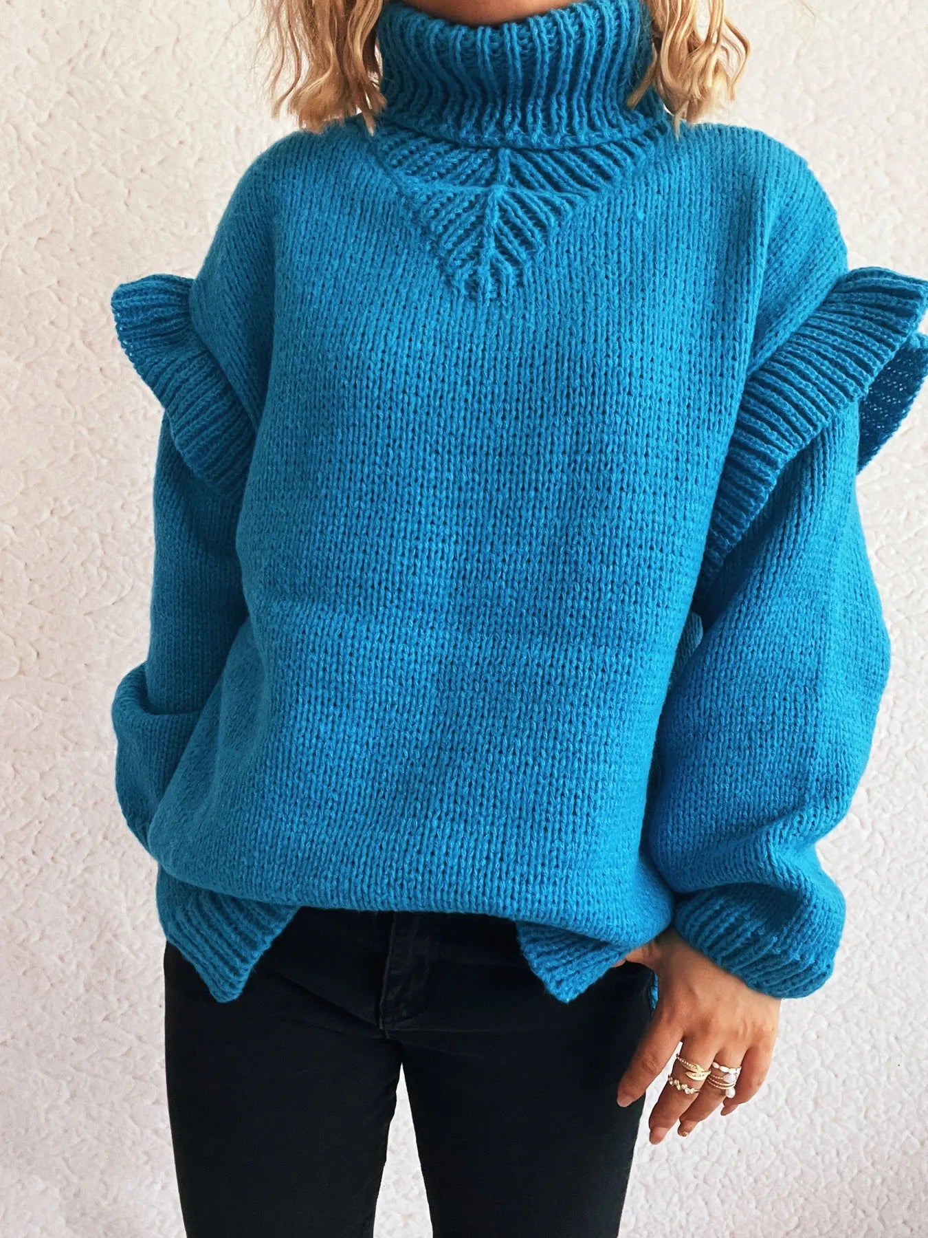 Blue ruffled turtleneck sweater with cable knit center detail