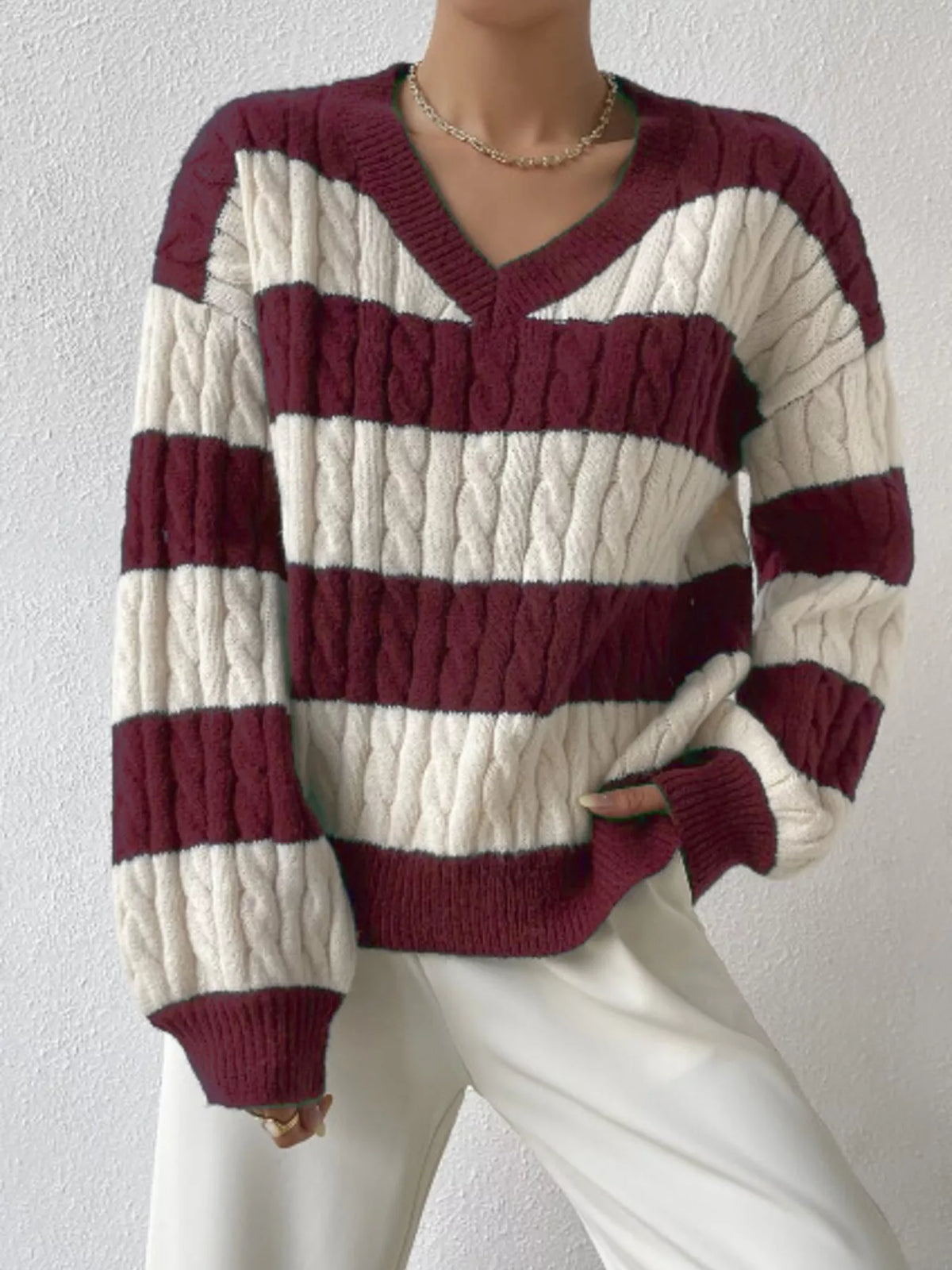 Burgundy and off-white striped cable knit V-neck sweater with long ribbed sleeves