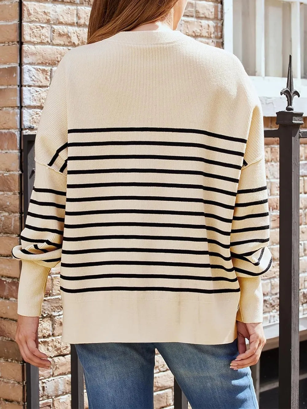 Back view tan sweatshirt with round neck and black horizontal stripe panel
